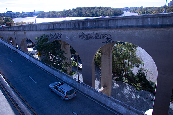 Graffiti on the side of a bridge. 