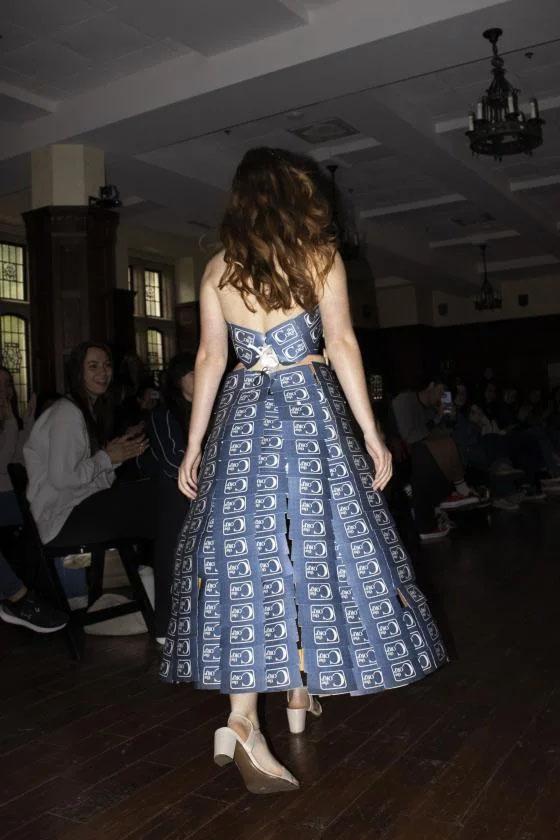 a shot of the back of the dress being worn on the runway