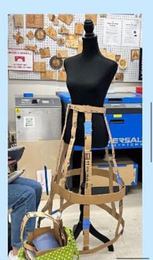 a cardboard dress frame being constructed around a sewing frame in the Maker Hub