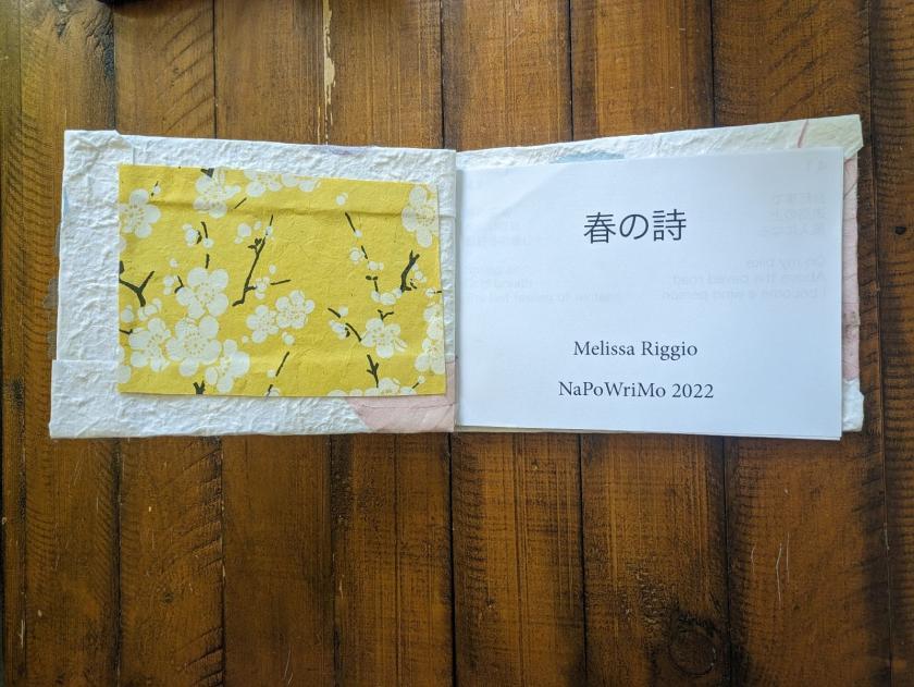 a book spread out showing a yellow, floral page on the left and the title page on the right
