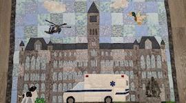 Image of a Quilt depicting Georgetown's Healy Hall, with and ambulance in front