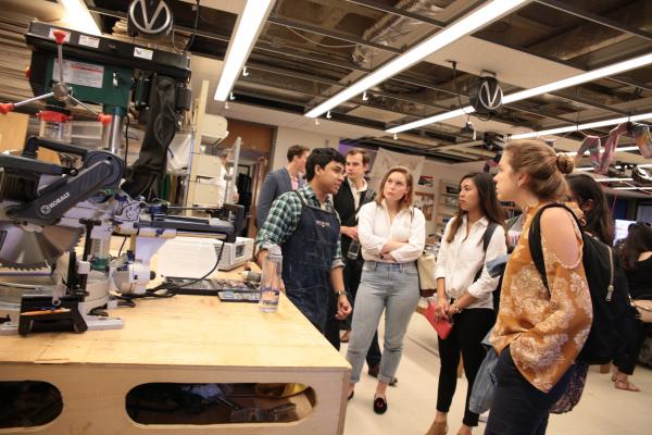 A Maker Hub volunteer gives a tour to a group of students