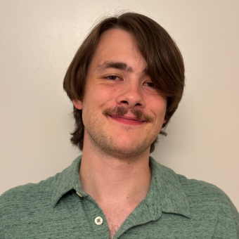 caucasian man with brown long hair and a mustache