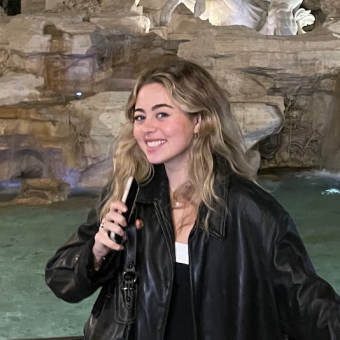 woman smiling and wearing a black leather jacket