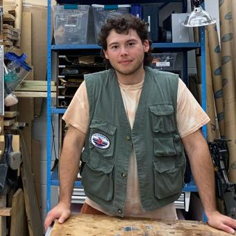 white man wearing green vest