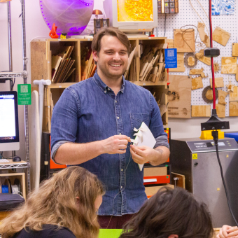 man wearing a blue button down shirt and smiling