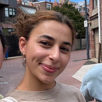 smiling woman standing on a city street