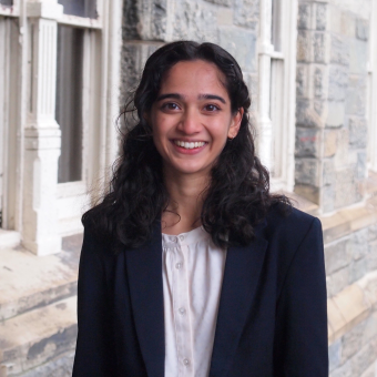 woman wearing a navy blazer and smiling