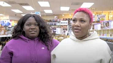 Two women being interviewed at a store. 