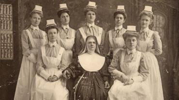 A black and white image of a group of nurses and nuns.