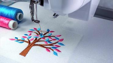 an embroidered tree with multicolored leaves