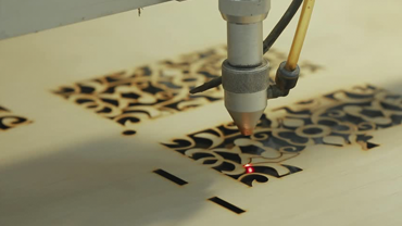 a laser cutting designs out of wood