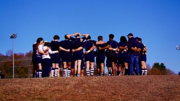 Rugby Players in a Huddle
