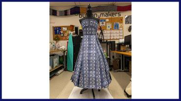 a blue dress on a mannequin made entirely of used coffee sleeves from the Corp