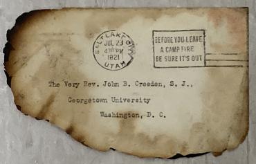 Envelope addressed to the GU president with charred edges