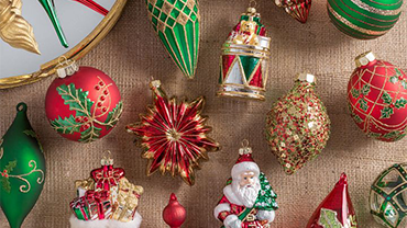 a top down view of red and green Christmas ornaments arranged on a table