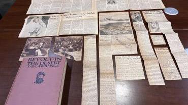 Amanda's copy of Revolt in the Desert on display with the newspaper clippings she found in the book