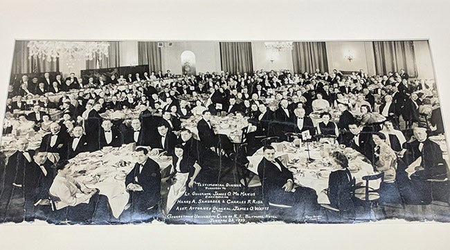 mended photograph of a large group of Georgetown University alumni sitting at tables in a banquet hall