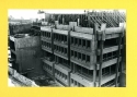 Photograph of Library construction, showing the concrete forms for the penthouse walls being constructed