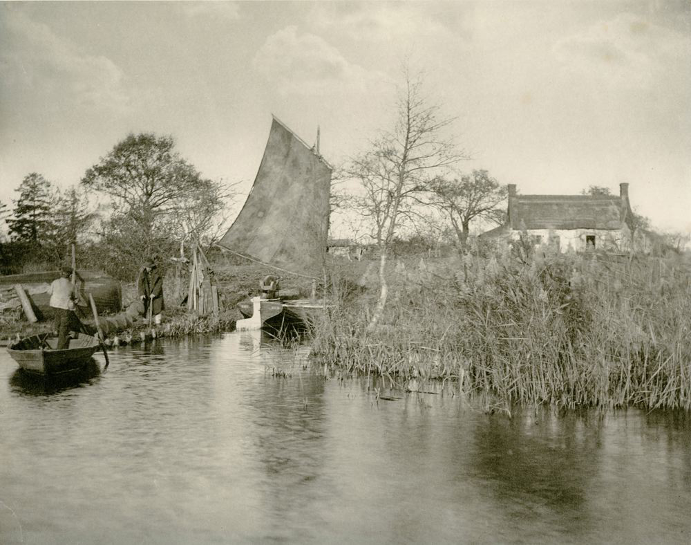 Ships on a pond near a farmhouse