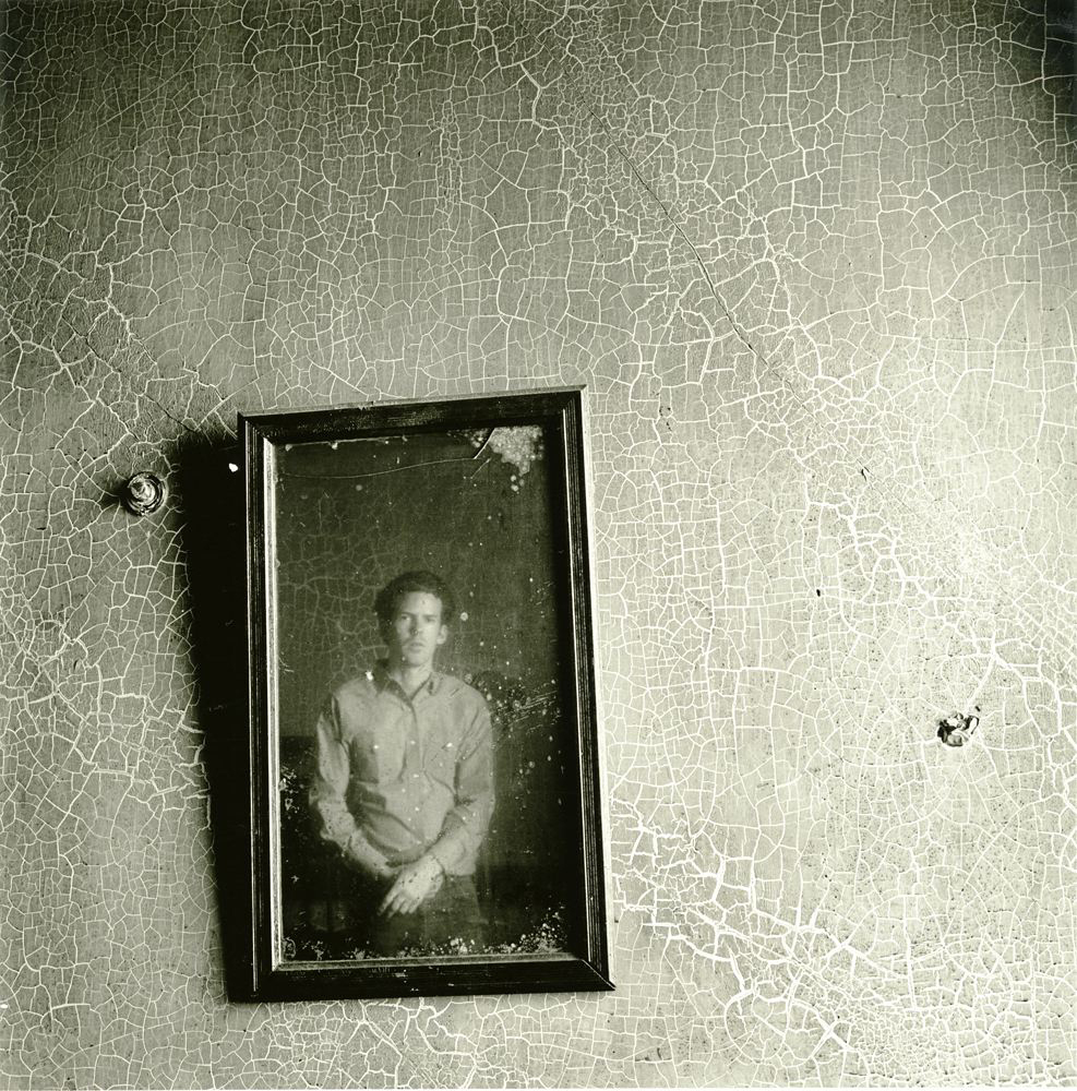 Portrait of a young man looking at a mirror