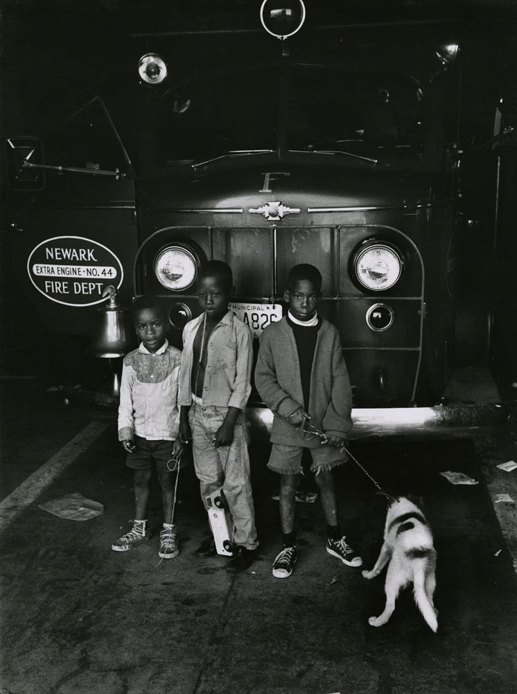 Children and a dog in front of a fire truck