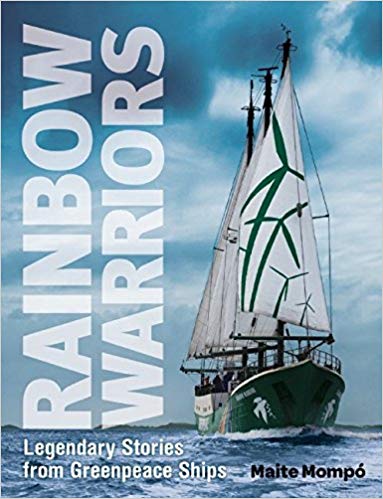 The book cover for Rainbow Warriors: Legendary Stories from Greenpeace Ships, showing a sailboat on the ocan that has windmills printed on its sails