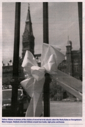 A ribbon tied to the gates of the University, with Healy Hall in the background