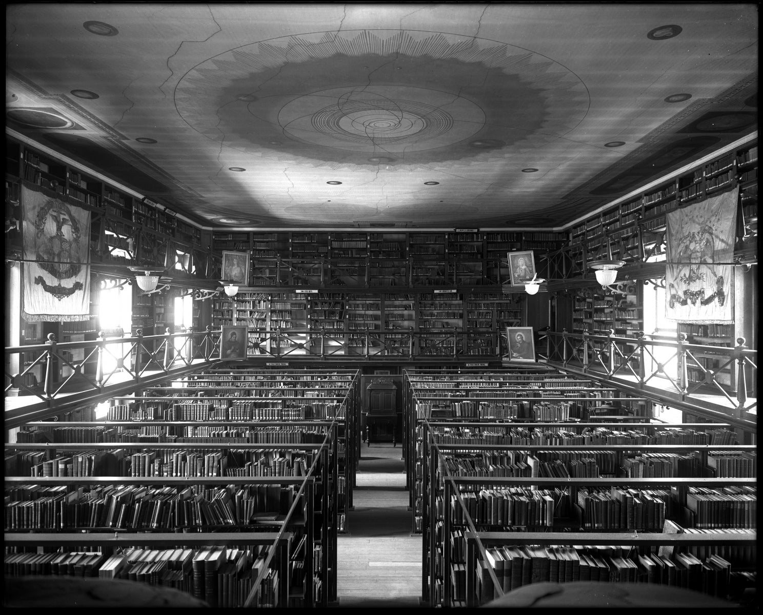 interior view of the shelving levels and artwork and the decorated ceiling of the old Woodstock Library