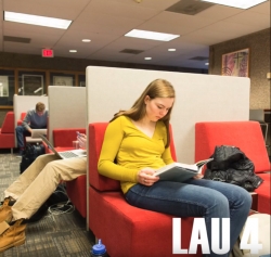A screenshot from the Floors of Lau video, showing a student sitting on a bench and reading a book, with the text Lau 4