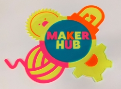 The Maker Hub logo cut out of multi-colored acrylic, showing the text Maker Hub in a circle surrounded by a ball of yarn, a circular saw blade, a gear, and an LED light bulb