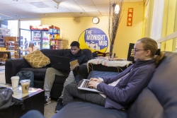 Two students work on their laptops in The Midnight Mug, a coffee shop on the second floor of Lauinger Library