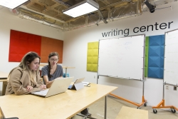 A student meets with a member of the Writing Center staff to review a paper